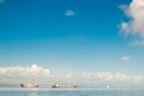 Shipping tanker on ocean and blue sky — Stock Photo