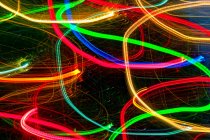 Abstract light trails on dark background. — Stock Photo