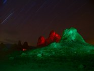 Lit up rock formations at night. — Stock Photo
