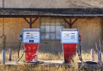 Gas pumps in an abandoned filling petrol station. — Stock Photo