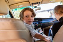 Young boy looking at camera in parked car. — Stock Photo
