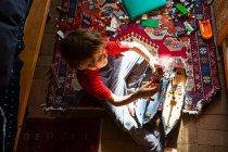 High angle view of young boy in his room playing with his toys — Stock Photo