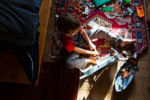 High angle view of young boy in his room playing with his toys — Stock Photo
