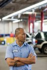 Portrait of Pacific Islander car mechanic in auto repair shop — Stock Photo