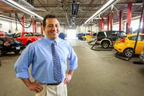 Portrait of Hispanic auto repair shop owner — Stock Photo