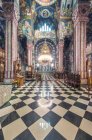 A Serbian Orthodox church interior in Ljublijana, murals, painted pillars and walls, and chandelier. — Stock Photo