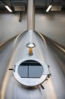 Interior of brewery, large steel storage tanks for brewing beer, inspection hatch — Foto stock