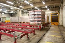Warehouse and distribution centre for goods, Steel platforms and pallets, lifting equipment and racking. Shrink wrapped cartons — Foto stock