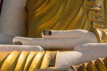 Hands of the large Buddha statue in the Kyaik Pun Pagoda a small Buddhist monastery near the town of Bago, Myanmar — Stock Photo