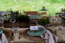 High angle close up of rustic place setting for a woodland naming ceremony. — Stock Photo