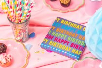 Birthday party table, with pink tablecloth — Stock Photo