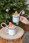 Christmas, mugs of egg nog with whipped cream and candy canes. — Stock Photo