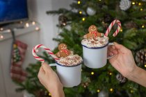Christmas, mugs of egg nog with whipped cream and candy canes. — Stock Photo