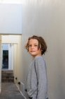 Portrait of young boy in a narrow alleyway, turning to look at the camera — Stock Photo