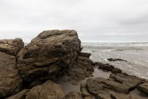 The jagged rocks and coastline of the Atlantic coast at Grotto Beach, a wide beach near Hermanus. — Stock Photo
