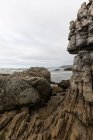 The jagged rocks and coastline of the Atlantic coast at Grotto Beach, a wide beach near Hermanus. — Stock Photo