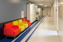 Corridor and waiting areas of a modern hospital with seating — Stock Photo