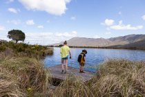 Teenage girl and younger brother exploring pond, Stanford Valley Guest Farm, Stanford, Western Cape, South Africa. — Stockfoto