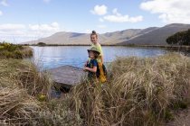 Teenage girl and younger brother exploring pond, Stanford Valley Guest Farm, Stanford, Western Cape, South Africa. — Foto stock