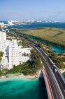 Aerial view over the hotel zone at Cancun, highway and high rise buildings, coastline. — Stock Photo