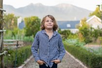 Portrait of eight year old boy smiling, hands in his pockets. — Foto stock