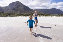 Children playing in surf, Grotto Beach, Hermanus, Western Cape, South Africa. — Stock Photo