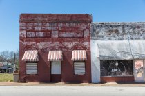 Abandoned storefronts and buildings with awnings in place, along a main stree — Stock Photo