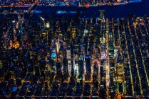 The city of New York City, Manhattan, aerial view at night. - foto de stock