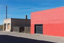 Empty buildings on Main Street, a warehouse with a red wall. — Stock Photo