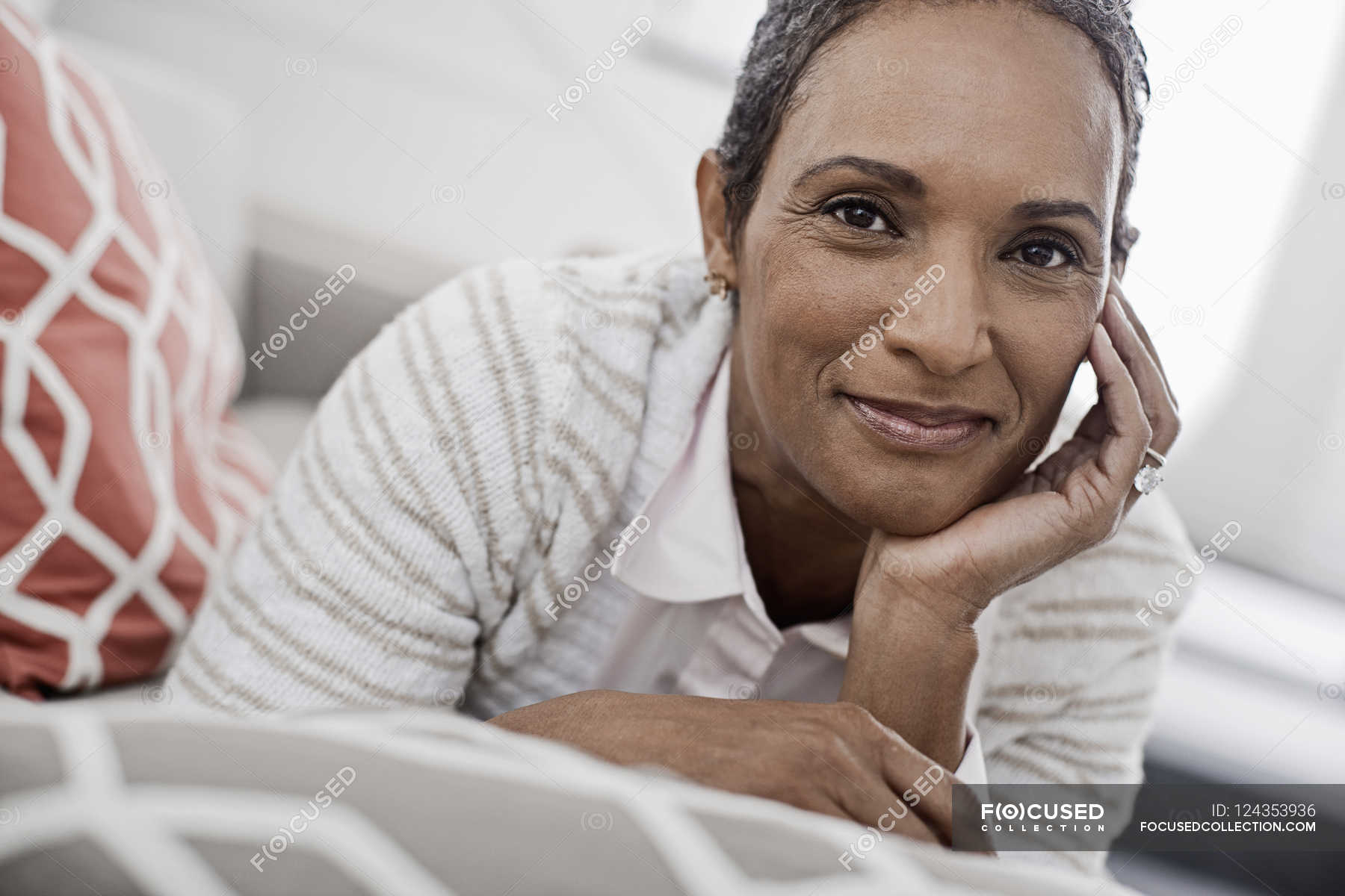 woman-at-home-lying-on-the-sofa-indoors-natural-light-stock-photo