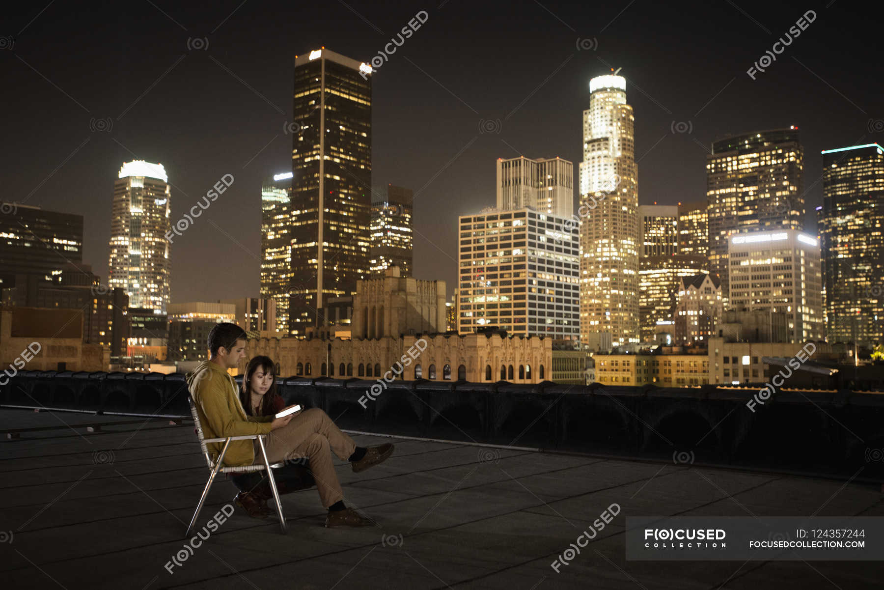 Couple On A Rooftop Overlooking City At Night Men Urban Scene Stock Photo