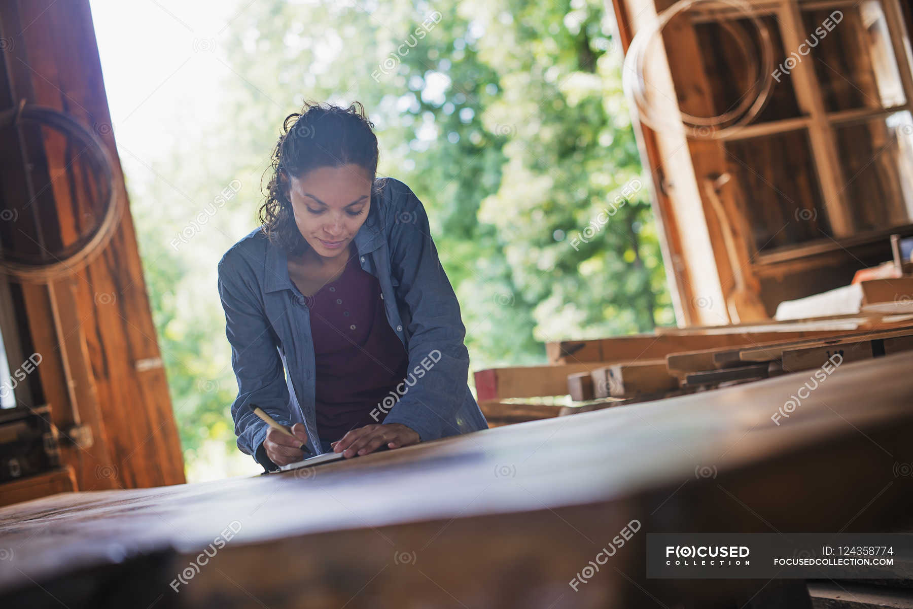 Woman Working With Reclaimed Timber Front View Mixed Race