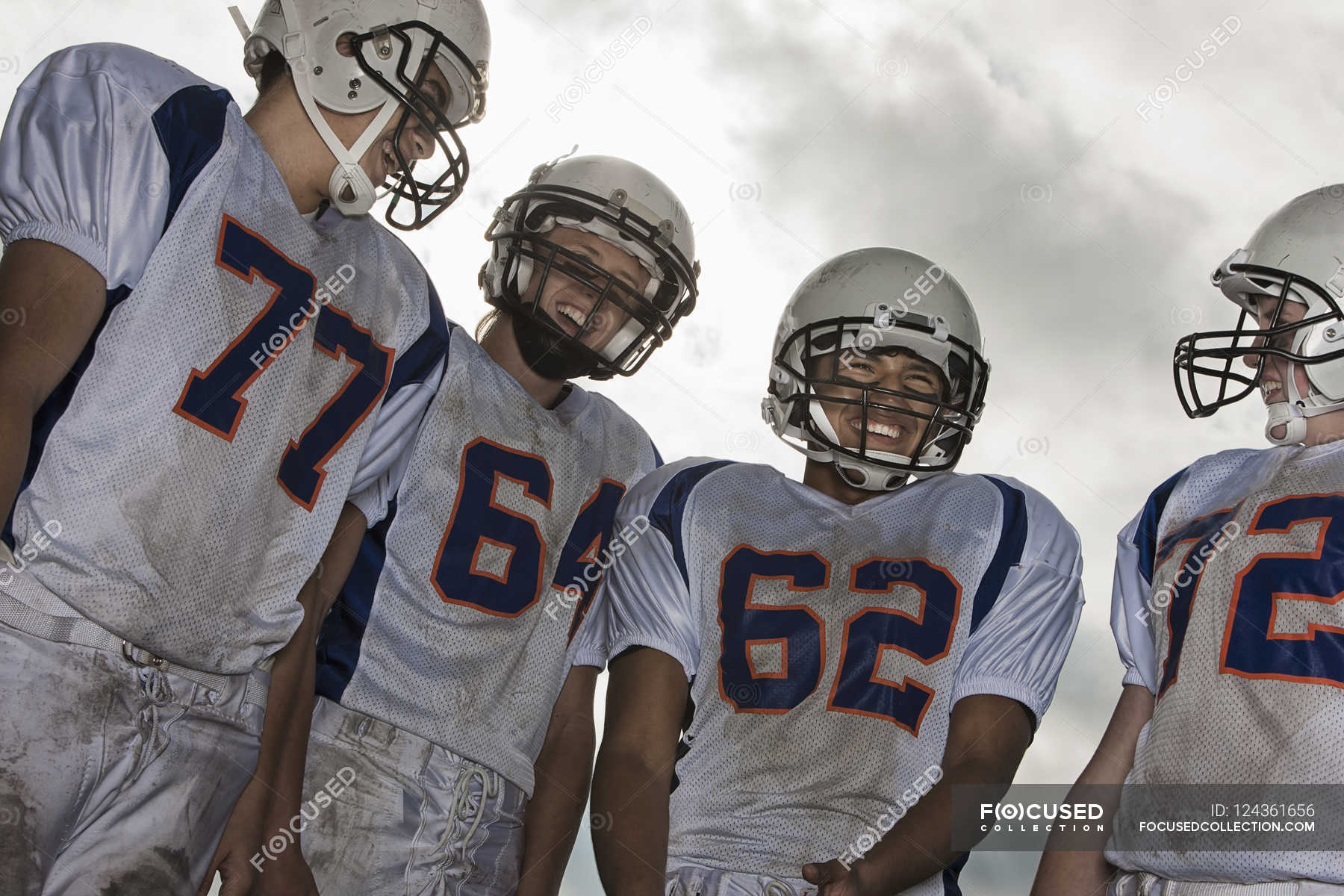 Football players in sports uniform — Sports Helmet, teenager - Stock ...