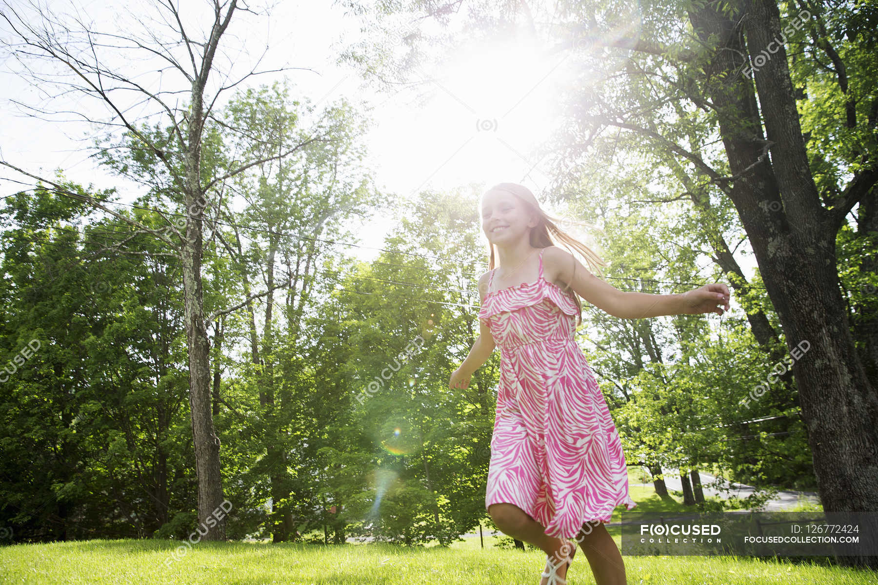 Girl running across grass — grounds, family Stock Photo 126772424