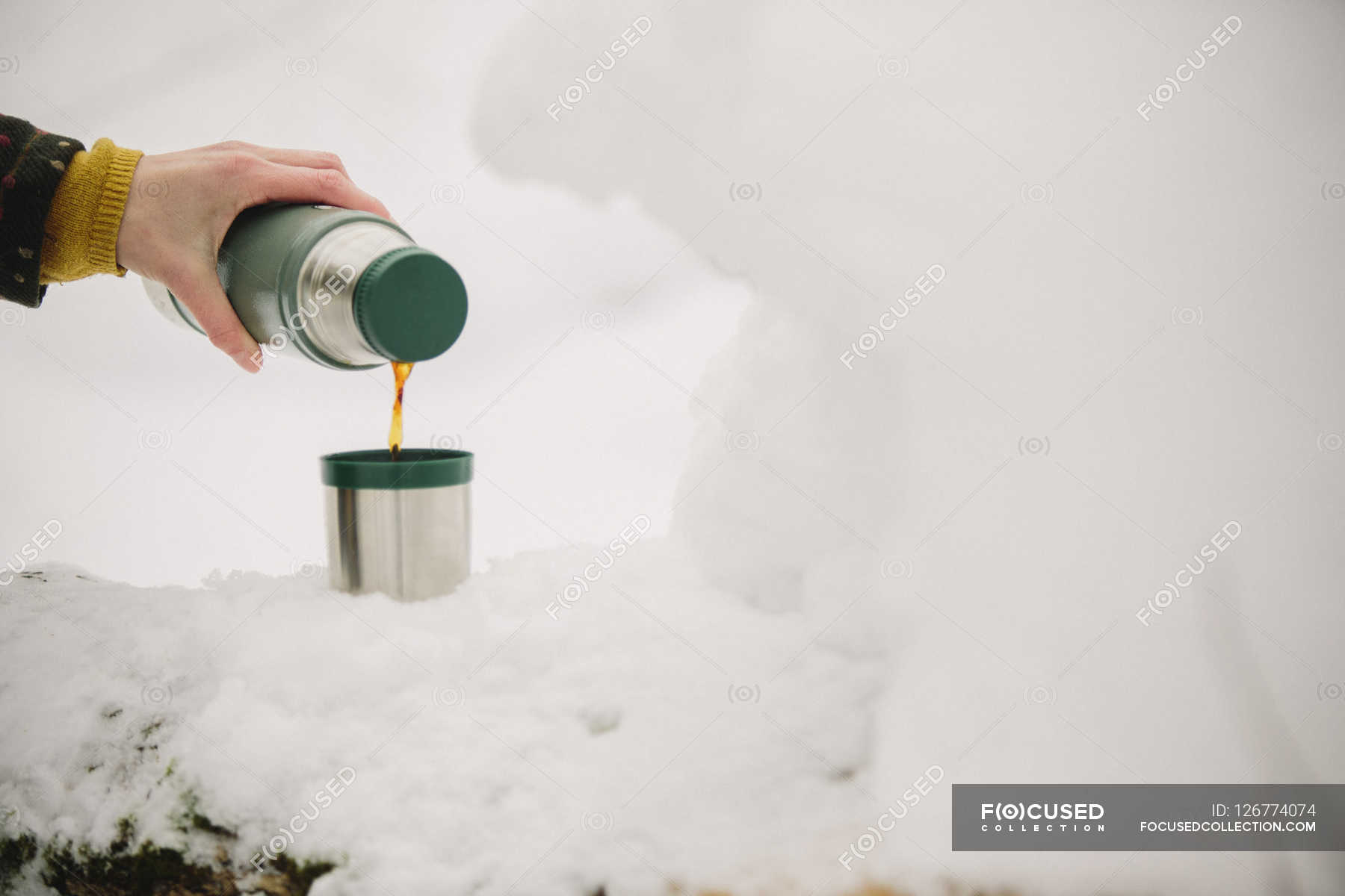 Pouring a drink from a flask — 1 Person, side view Stock Photo