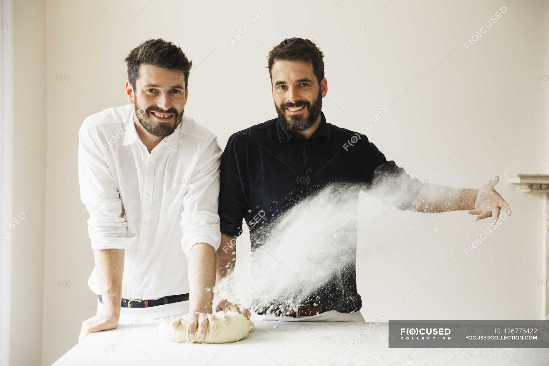 Bakers dusting bread dough with flour — Bristol, fun Stock Photo