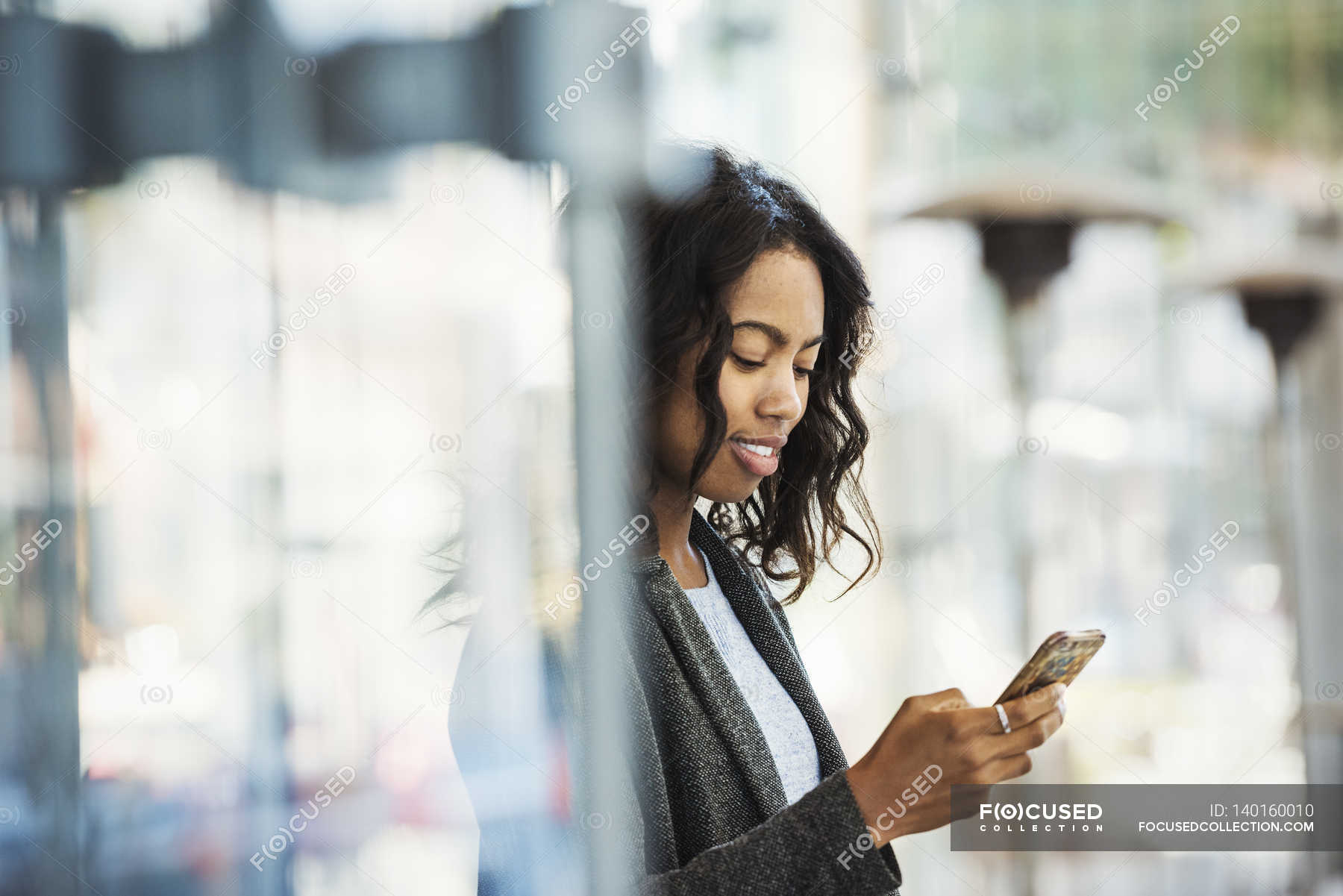 Woman checking mobile phone — device, cell phone - Stock Photo | #140160010