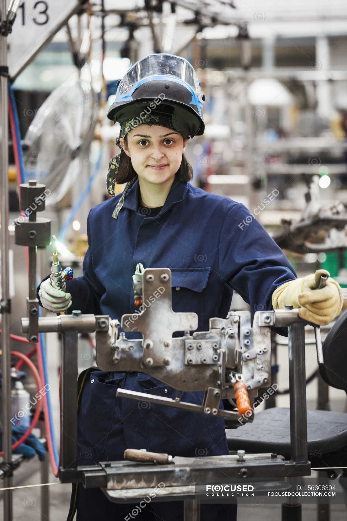 female-skilled-factory-worker-outerwear-25-30-years-stock-photo