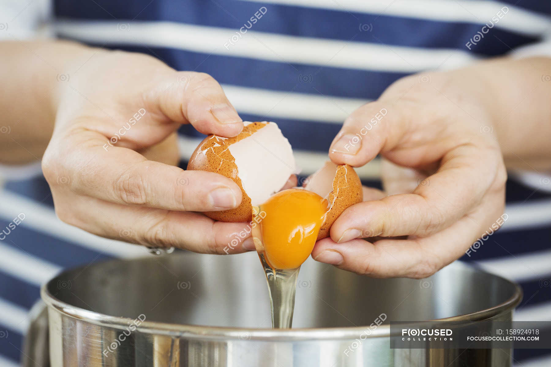 Person separating egg — Baker, eggshell Stock Photo 158924918