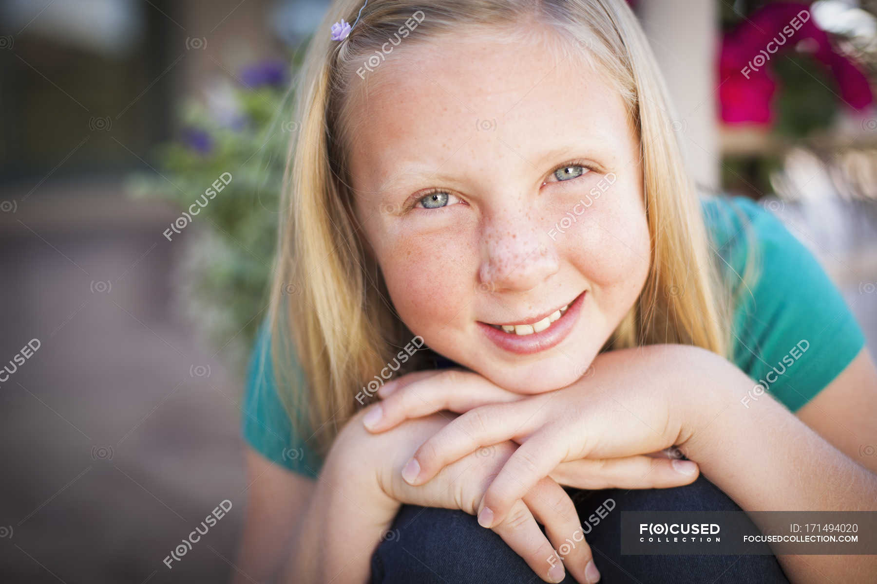 Girl Leaning Forward And Smiling In Camera — Innocence Hand On Chin