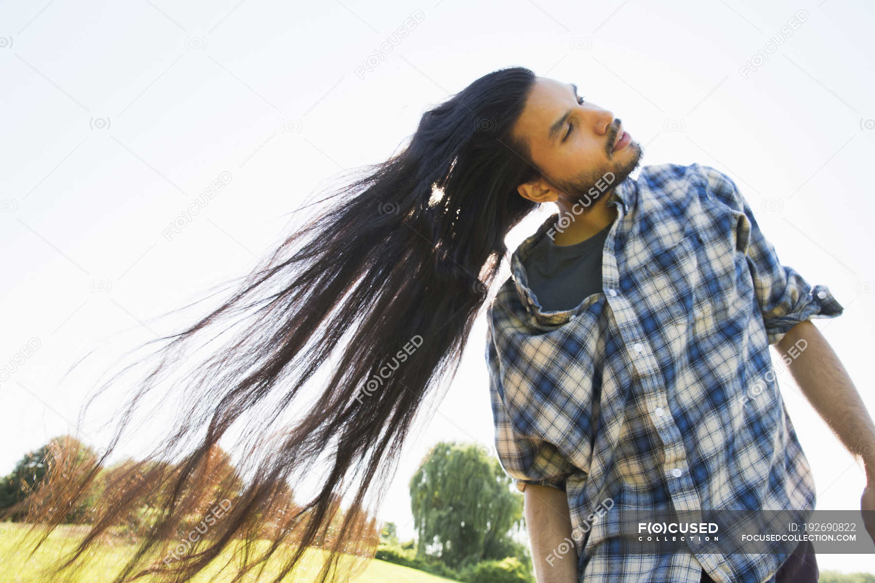 Young Man With Long Dark Hair Shaking Head And Fanning On Fresh