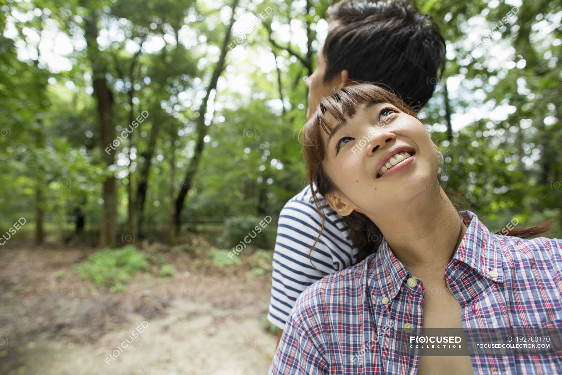 Young Woman Leaning On Man Shoulder And Looking Up In Forest. — People ...