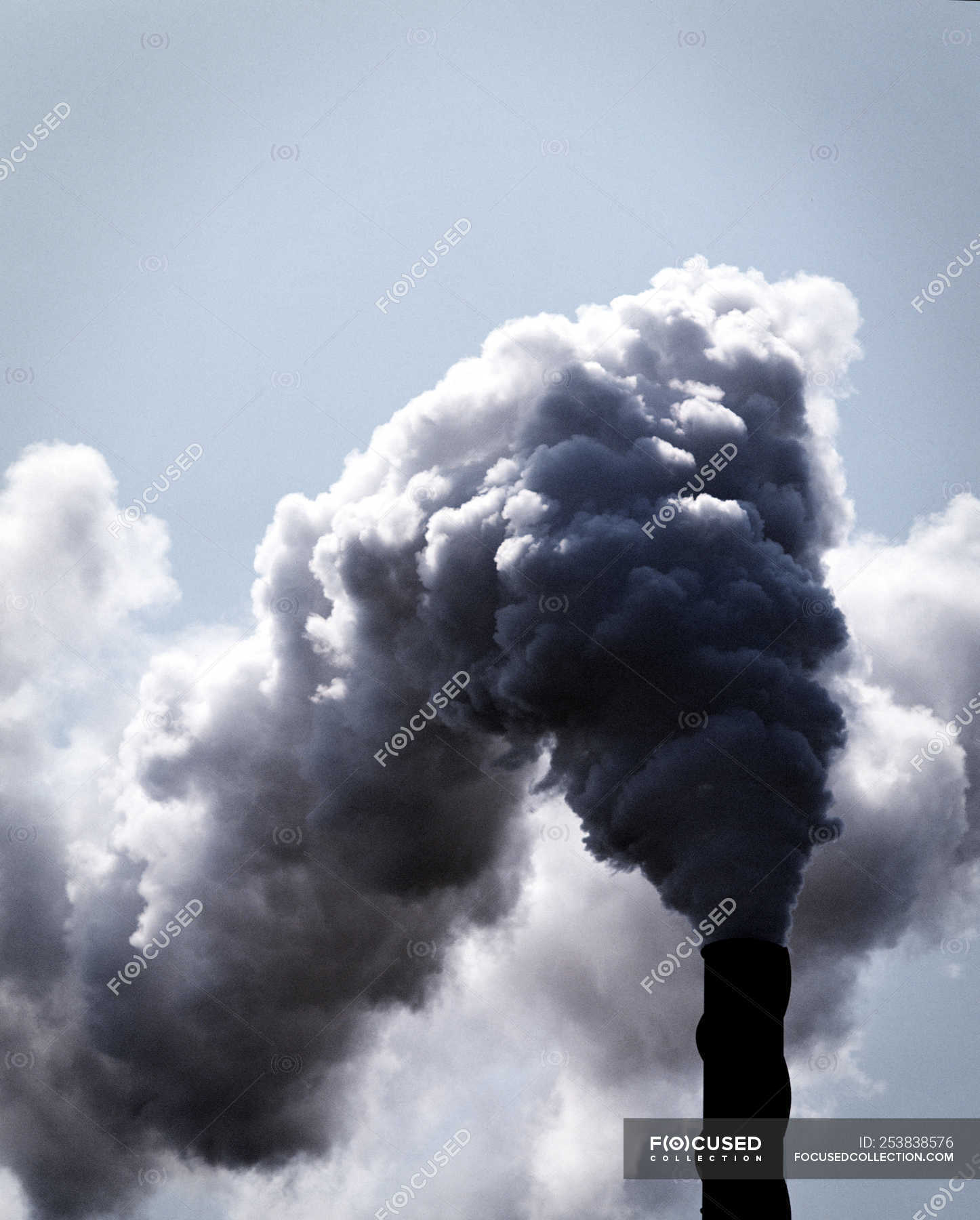 Industrial smokestack with clouds of industrial smoke — weathered