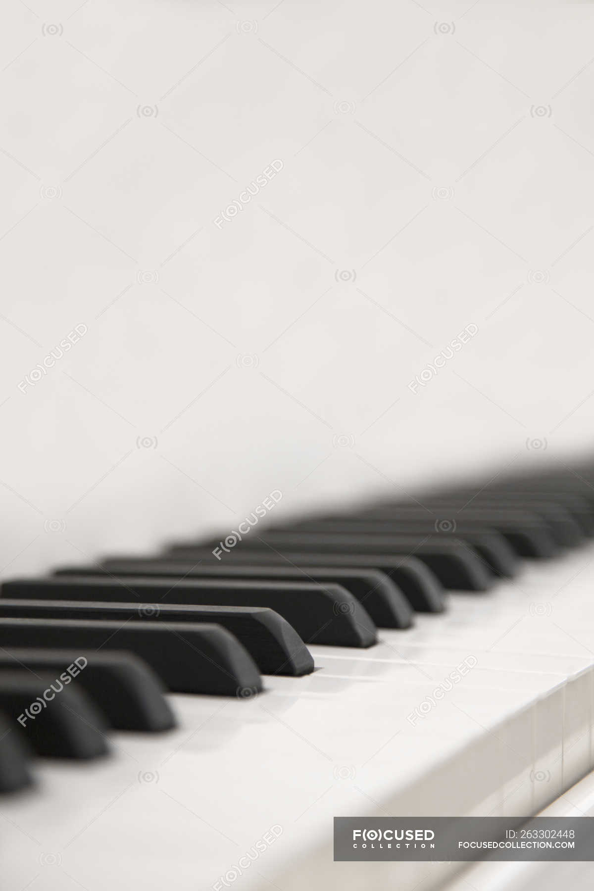 Close-up of black and white piano keys in selective focus. — Studio