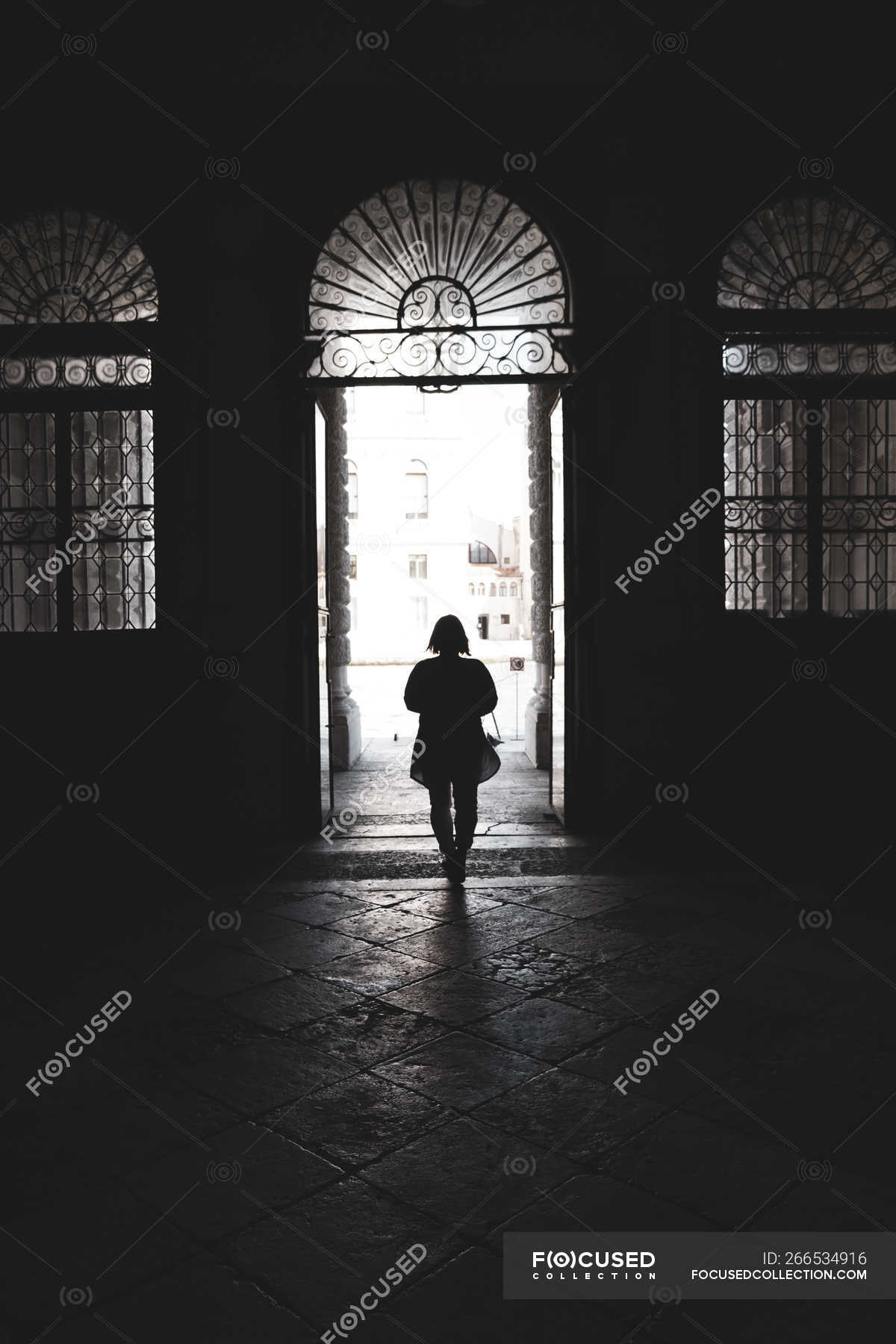 Silhouette Of Woman Walking Through Arched Doorway In Venice Veneto Italy — Vertical Tourist 9364