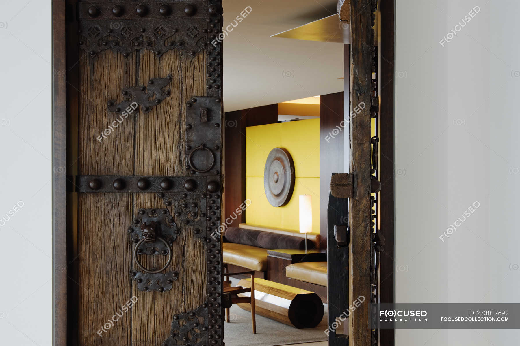 Open Wooden Ornate Door To Living Room Of House