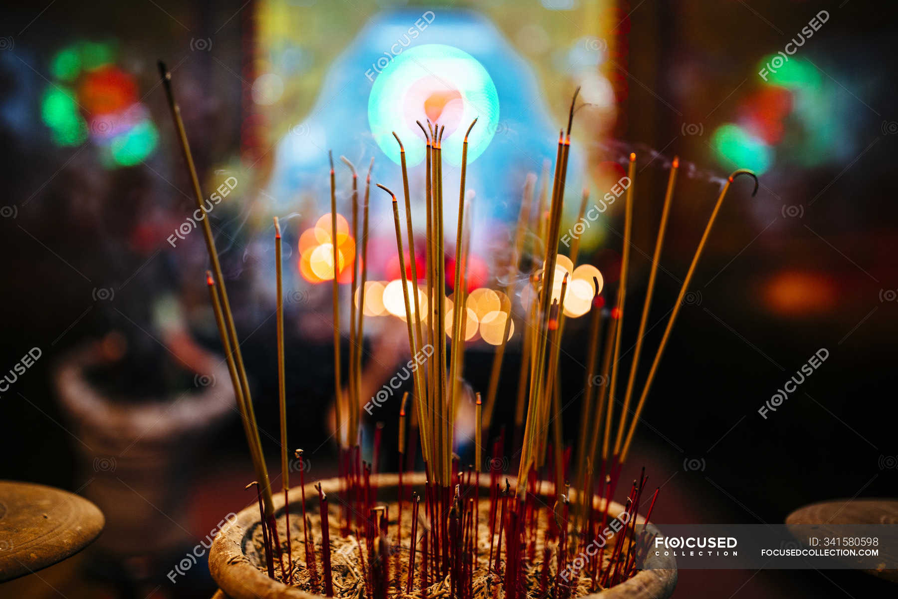 High angle closeup of incense at Asian temple. — spirituality, ong