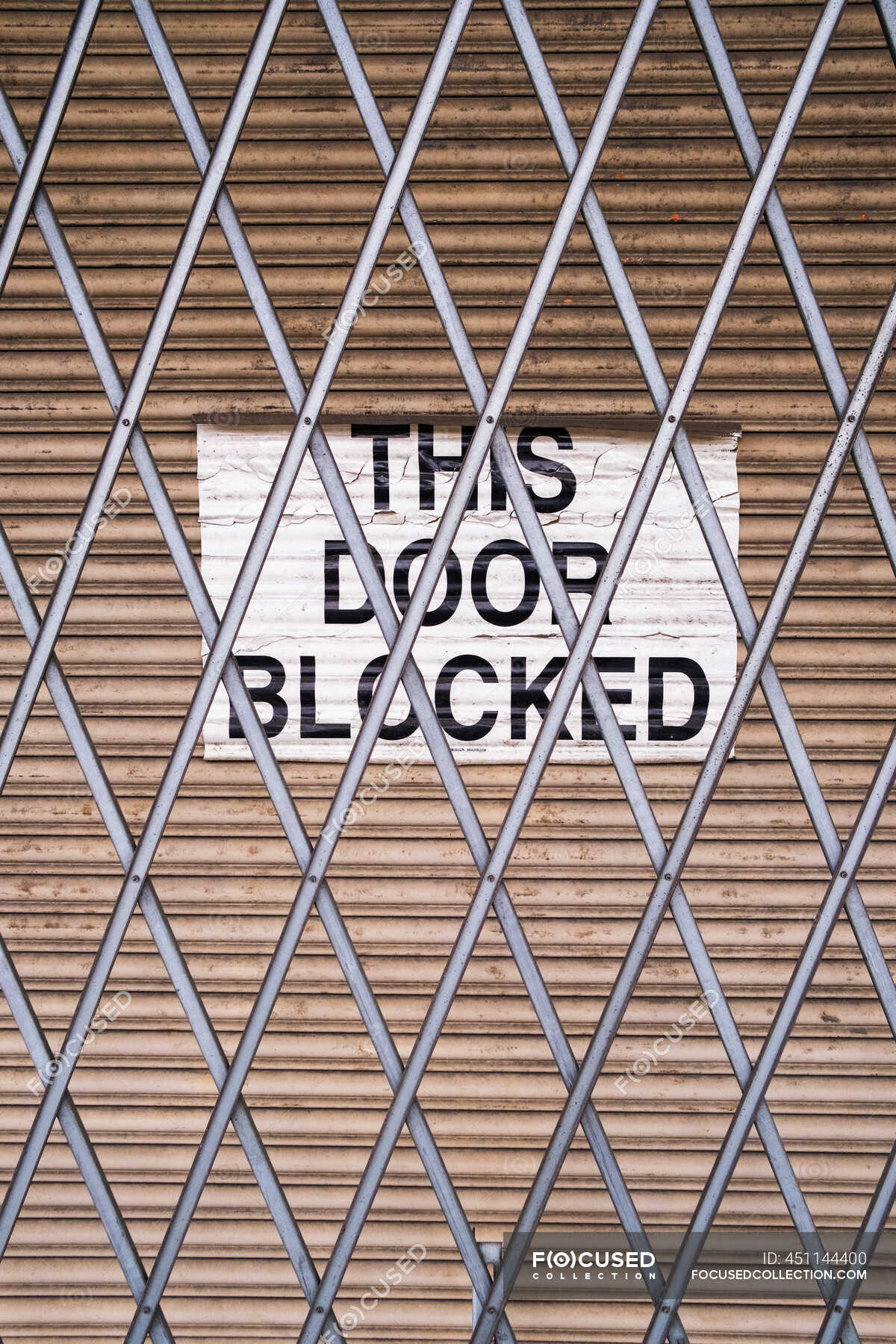 "This Door Blocked" sign on loading zone warehouse doorway — texture
