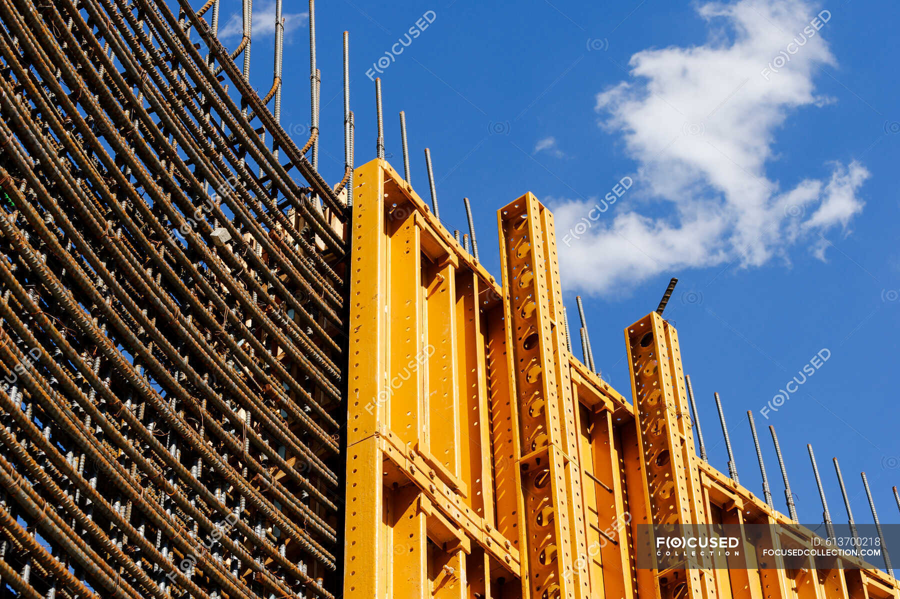 The exterior of a construction site, a high rise building, rebar