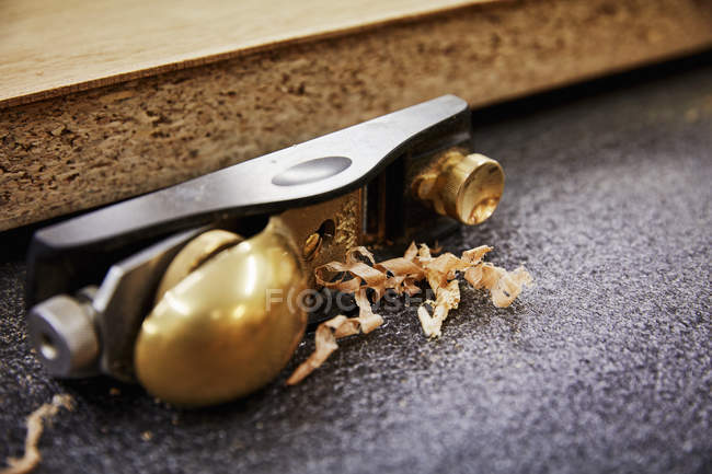 Wood plane with a brass handle — Stock Photo
